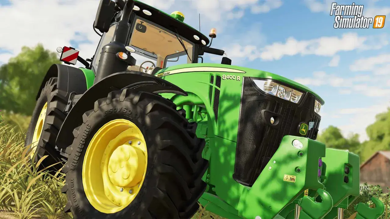 Zielony traktor John Deere 8400 R z gry ls19 na polu.