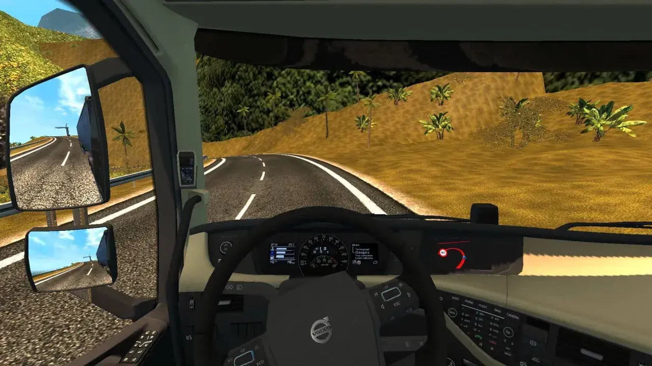 Widok z kabiny ciężarówki w ETS2. Widać kierownicę, deskę rozdzielczą z prędkościomierzem i obrotomierzem, a także lusterka boczne. Na drodze widać znak ograniczenia prędkości 60. Retarder jest kluczowy na zjazdach.