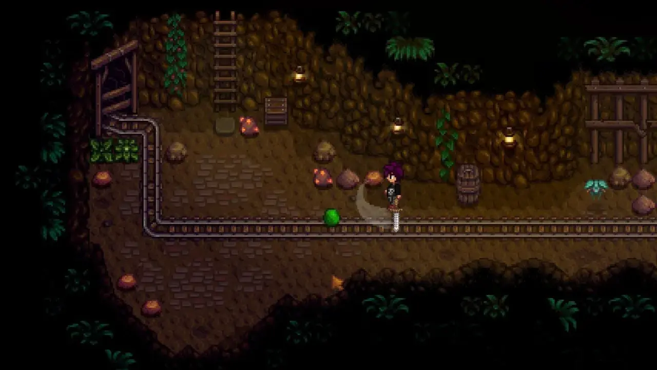 Postać w kopalni Stardew Valley walczy z zielonym potworem. To świetny moment na poradnik!