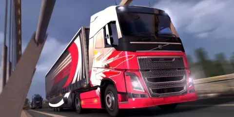 Czerwone ciężarówki ets2 z efektownymi grafikami pędzą po autostradzie.