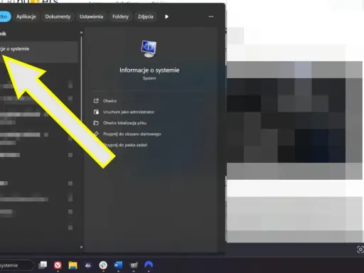 Strzałka wskazuje "Informacje o systemie", gdzie można sprawdzić ustawienia, w tym UEFI Secure Boot.