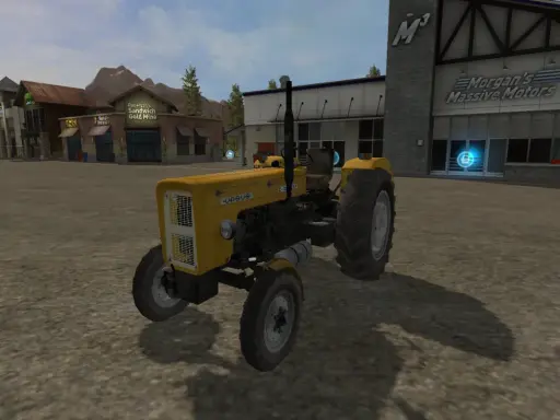 Żółty Ursus C-360 FS17 na placu przed budynkami.