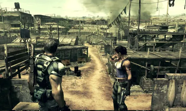 Chris i Sheva w zrujnowanej wiosce, przygotowani do walki w Resident Evil 5 Remake.