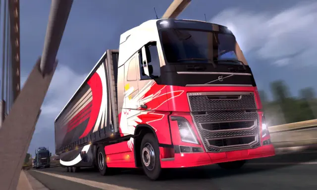 Czerwone ciężarówki ets2 z efektownymi grafikami pędzą po autostradzie.