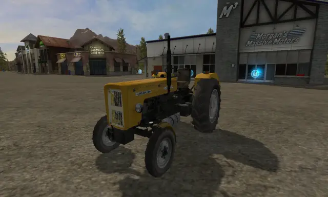 Żółty Ursus C-360 FS17 na placu przed budynkami.